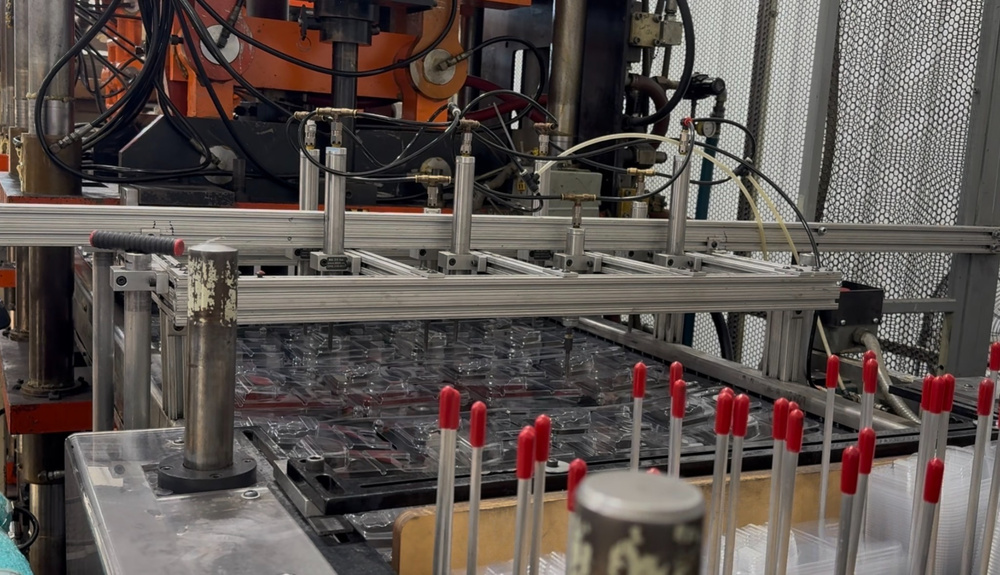 Thermoforming equipment producing clear plastic packaging at Stang Precision